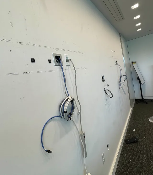 Conference room wall with new cable pulls and power before display mounting
