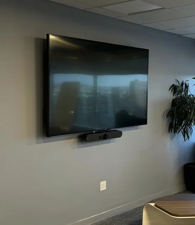 85-inch display on a cantilever wall mount with video bar below