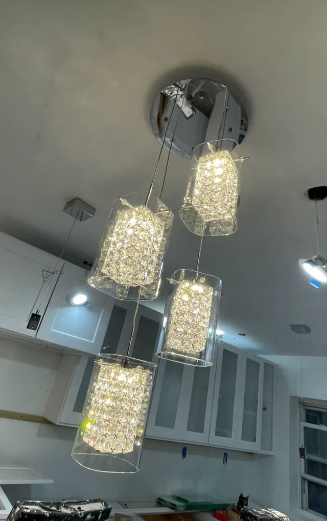 Cluster of crystal pendant lights hanging from a ceiling canopy