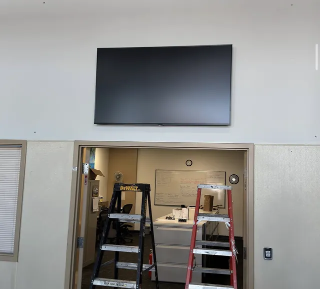 Display mounted above an office doorway with ladders below