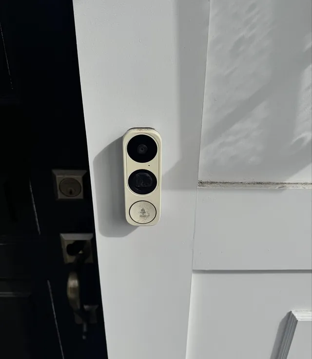 Video doorbell installed beside a front door