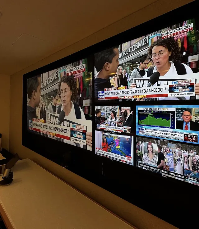 Video wall of multiple displays showing live news feeds