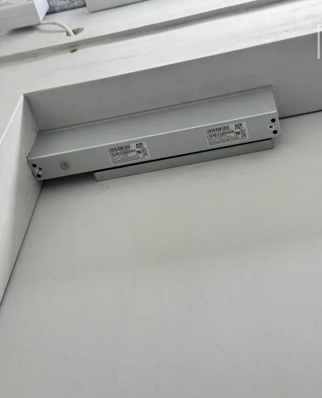 Close-up of a magnetic door lock mounted on a door frame