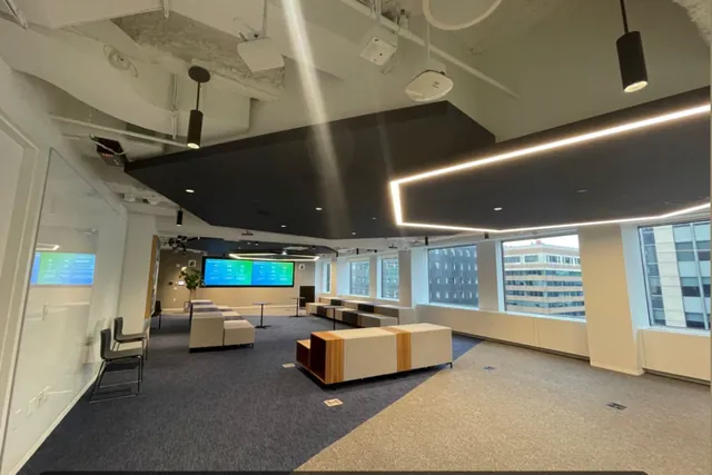 Finished modern office with linear ceiling lights and display wall