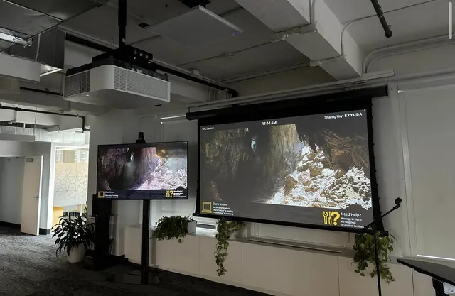 Open office with projector screen and secondary display