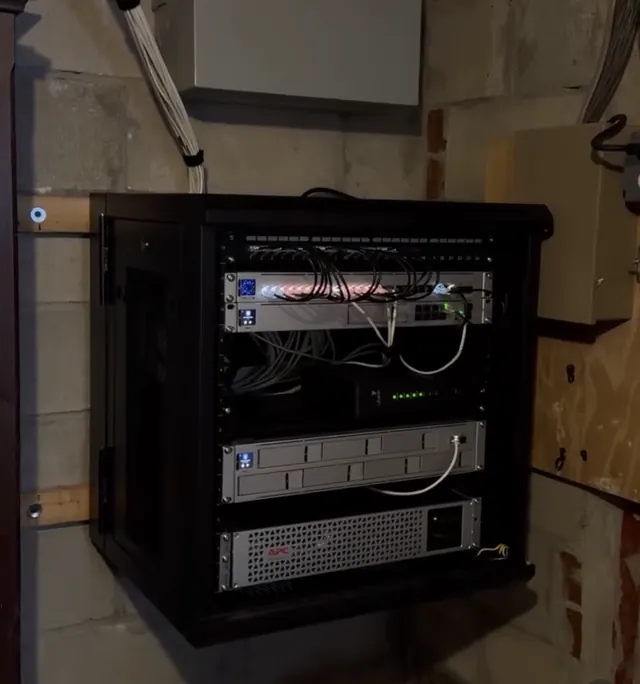 Wall-mounted equipment rack with network switch, recorder and UPS after security upgrade