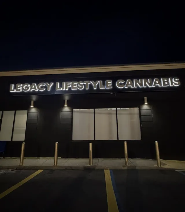 Illuminated storefront sign at night after rewiring