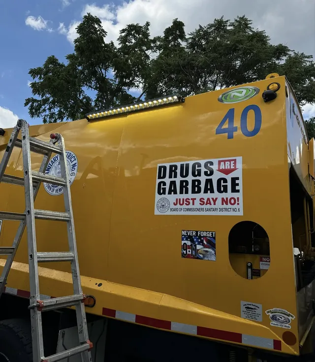 Rear of a yellow municipal truck with LED light bar installed